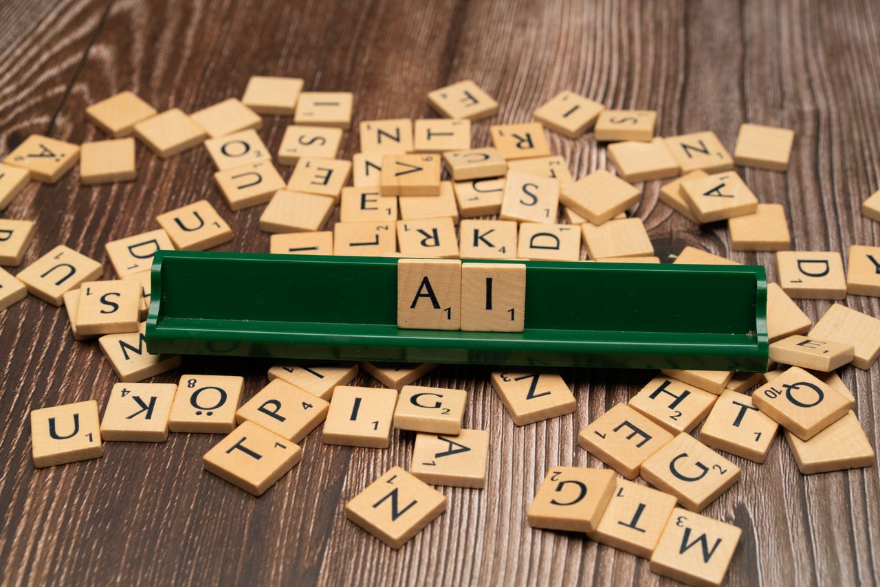 team-03 Wooden letter tiles spelling AI, representing technology and innovation.