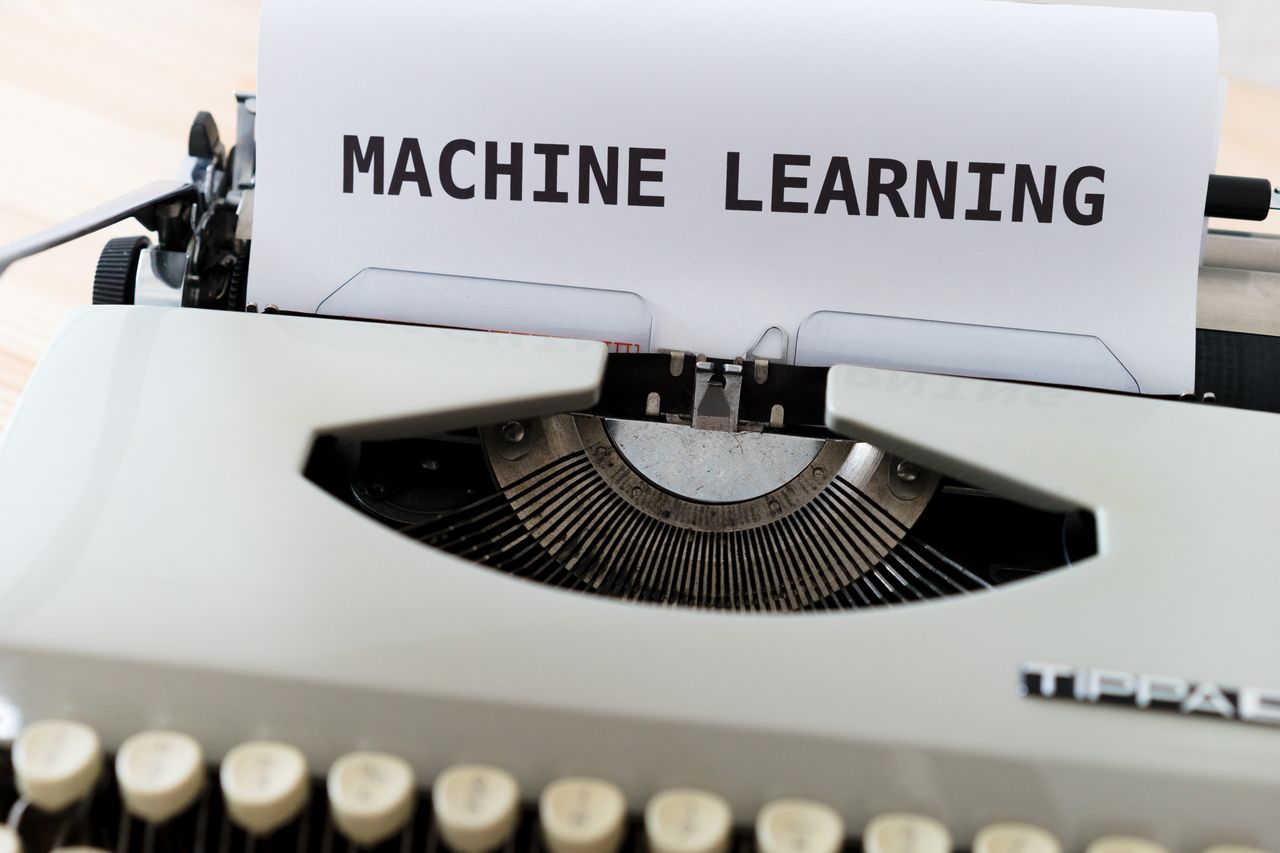 services-02 Vintage typewriter displaying 'Machine Learning' text, blending old and new concepts.