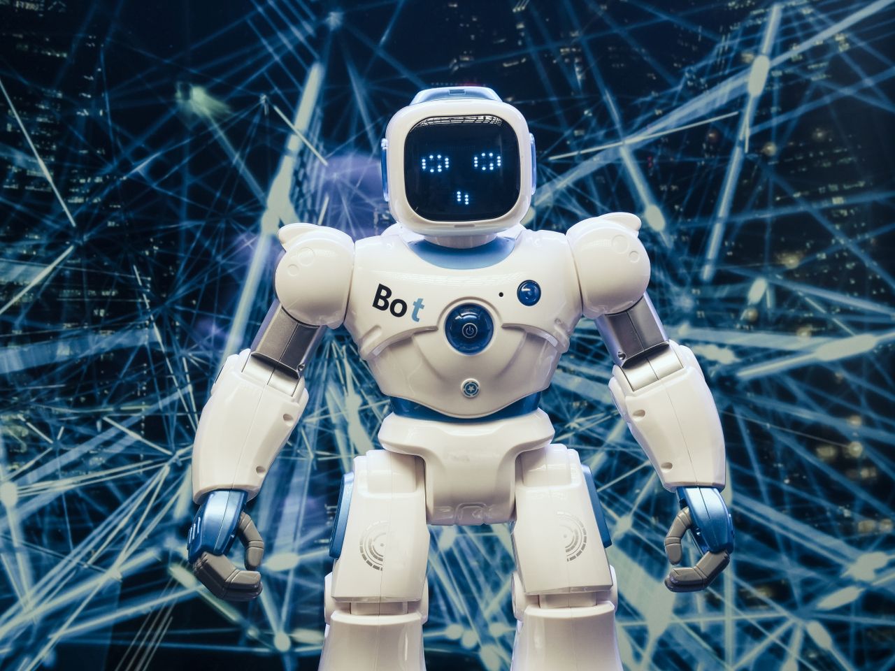 team-01 A modern humanoid robot with luminous features set against a digital network backdrop.